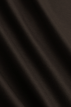 Close-up of a brown mercerised cotton fabric with subtle folds, showing its smooth, lustrous finish.