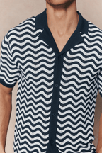 Serenita Ecru/Navy knitted shirt with wavy pattern, open collar, and full button placket.