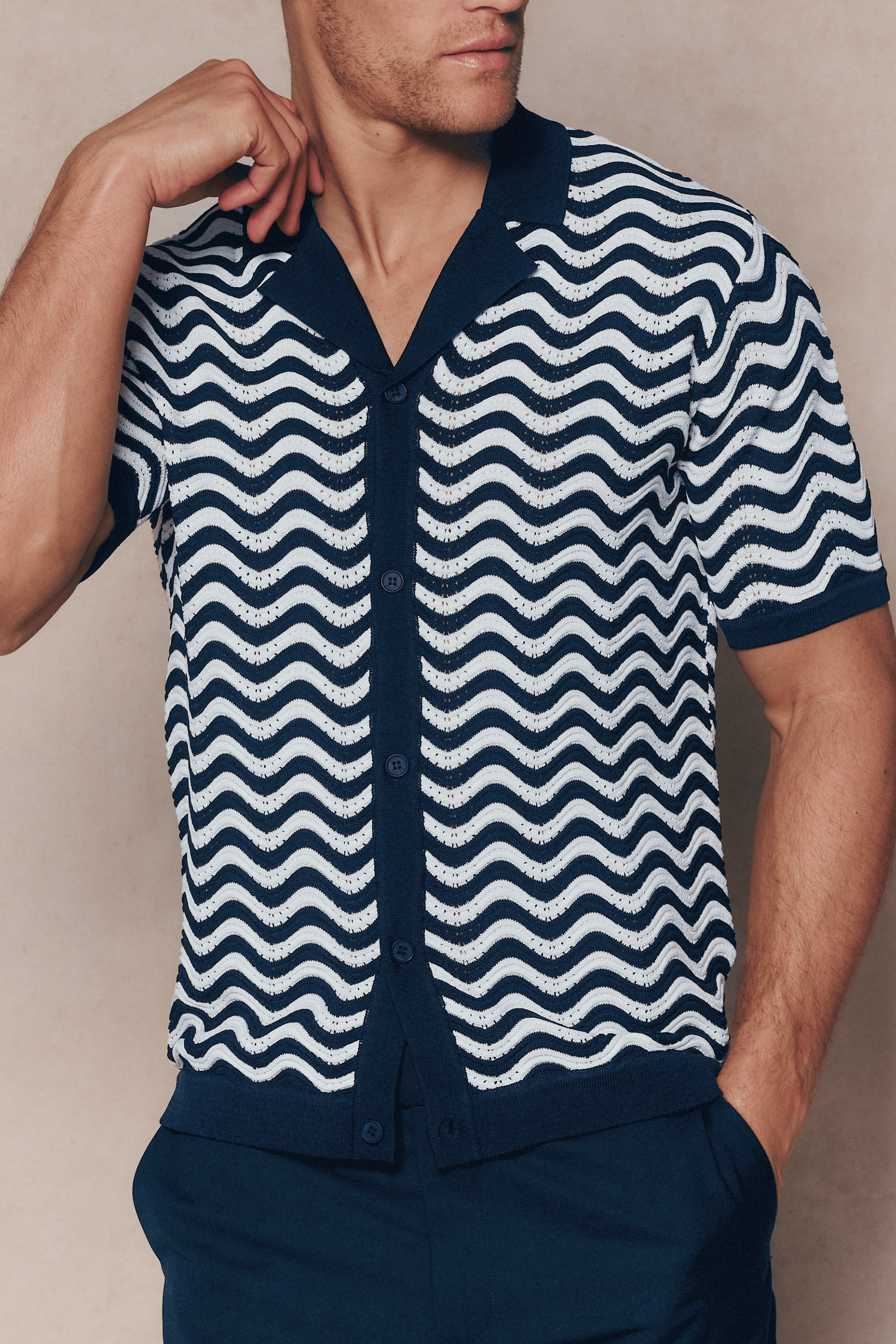 Serenita Ecru/Navy knitted shirt with wavy pattern, open collar, and full button placket.