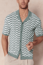 Man wearing a sage/white Serenita knitted shirt with a wave pattern, button-through front, and open collar.