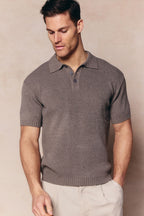 Man wearing a dark sage Sorelle short sleeve ribbed knit polo with a classic collar and button placket.