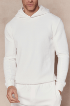 Man wearing an ivory Zarco crinkled jersey hoodie and matching sweatpants.